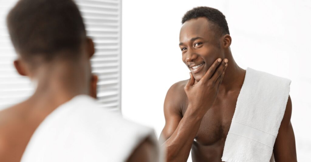 Rejuvenate: 5 Popular MedSpa Injectables 4 Black Man Smiling And Touching His Chin