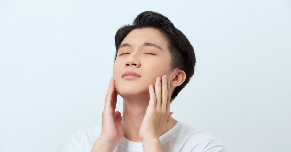 Asian man touching his face image showing concept of 10 Common Skincare Mistakes and Simple Fixes